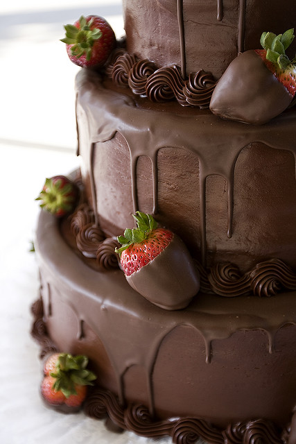 Chocolate frosting wedding cake and chocolate covered strawberries