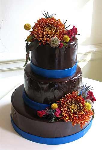 This three tiered circle cake is slathered in bittersweet ganache and 