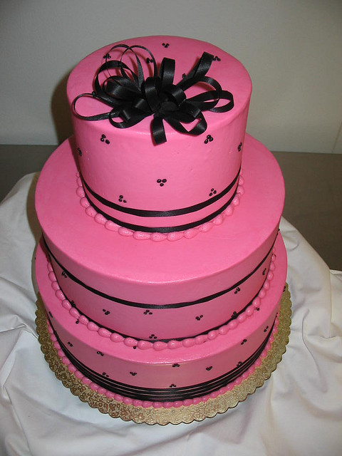 Hot pink smooth as glass frosting is tangled up in thin black ribbons