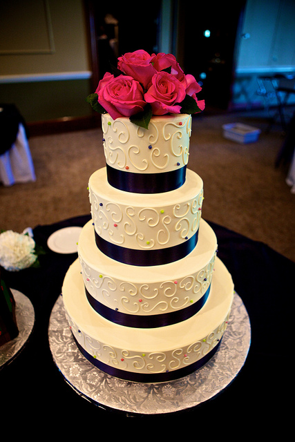 Four stacked layers decorated simply with buttercream white on white 