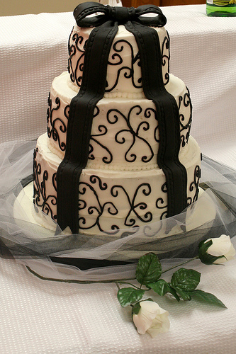 The buttercream is covered in a gorgeous black scroll work pattern
