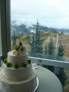 White wedding cake with green mums