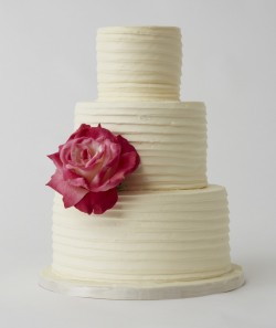 white cake with red rose