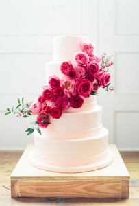 white cake with pink flower cascade